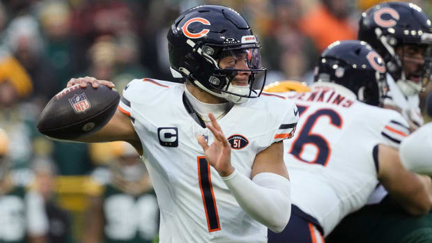Justin Fields pulls back the football in one hand to throw